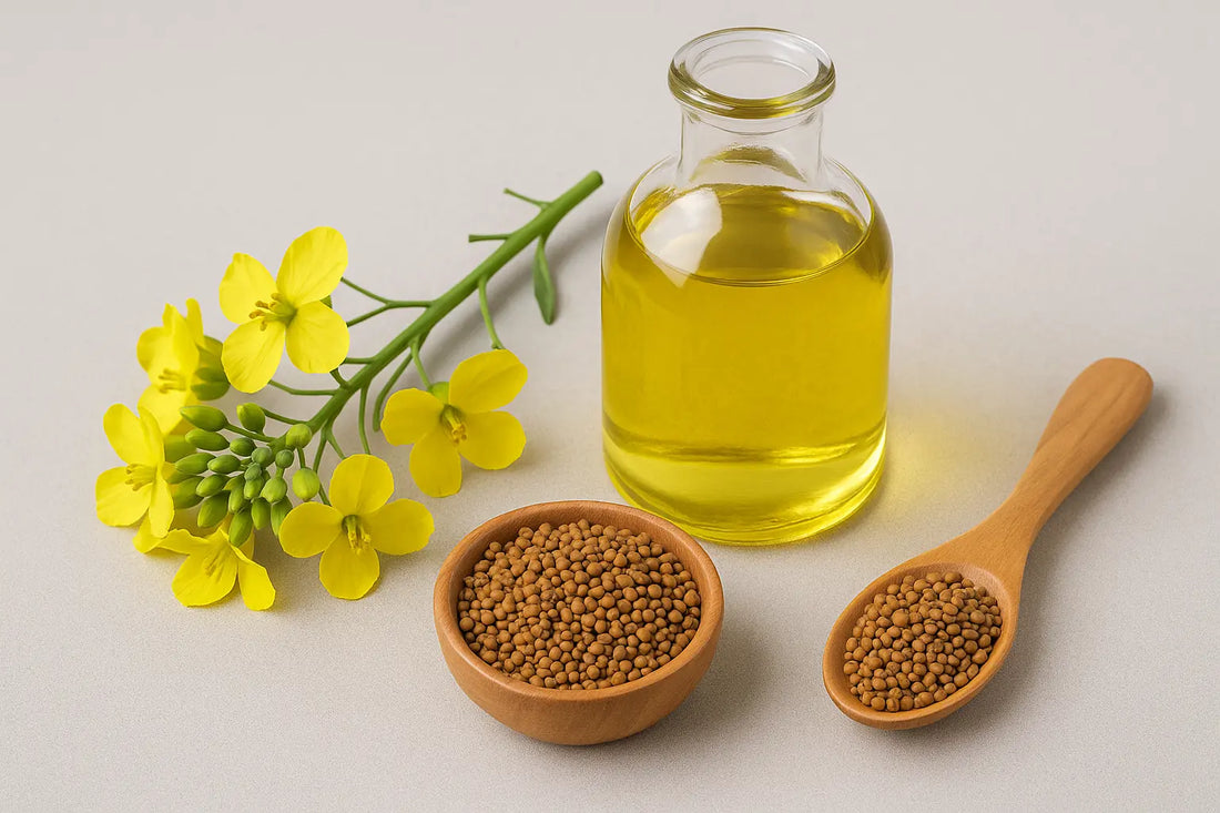 Canola oil in a glass bottle with yellow canola flowers and seeds.