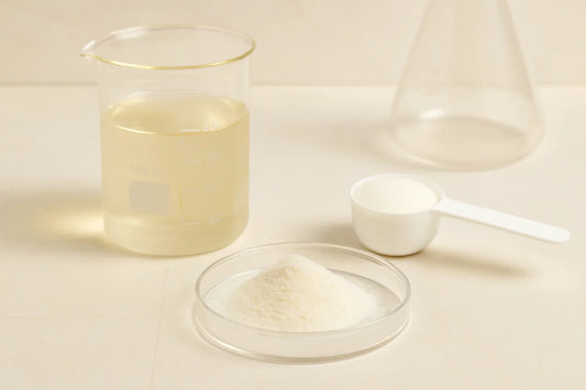 Hydrolysed collagen peptides (Type I & III) powder in a glass petri dish with a beaker and scoop in a neutral lab scene – Ingredients & Science | Maxine’s Burn Malaysia