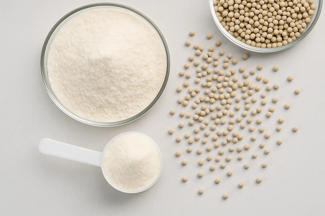 Polydextrose powder and granules in glass bowls and scoop on a neutral background.