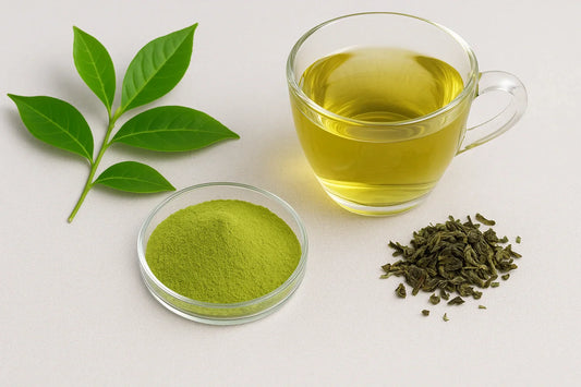 Fresh green tea leaves, powdered extract in petri dish, dried leaves, and glass cup with green tea liquid on a neutral surface.